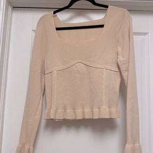 Large tan fitted shirt with ruffled sleeve